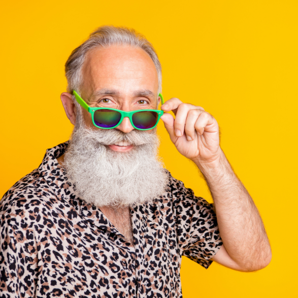 Smiling man with long white beard and green sunglasses