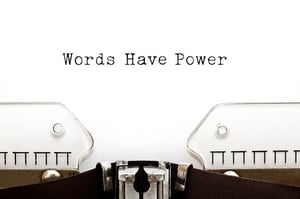 A page in a typewriter features the copy Words Have Power.