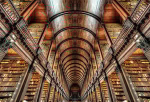 A vast library filled with sleek angles and rows and rows of books. 