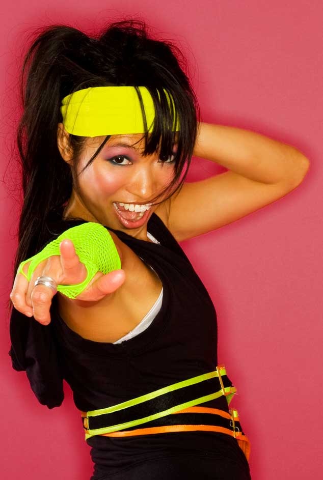 Woman in workout gear pointing at screen and ready to kick-start marketing and sales 