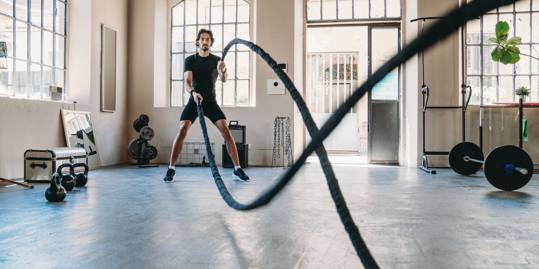 Man exercising with ropes at a gym