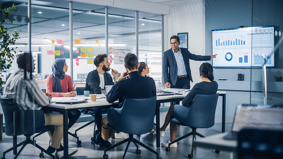 Group of people at a table in an office conference room reviewing data