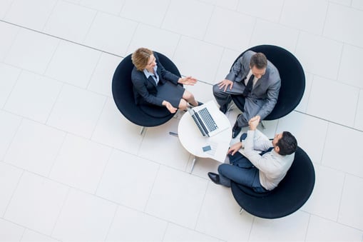 Three businesspeople seated in a circle