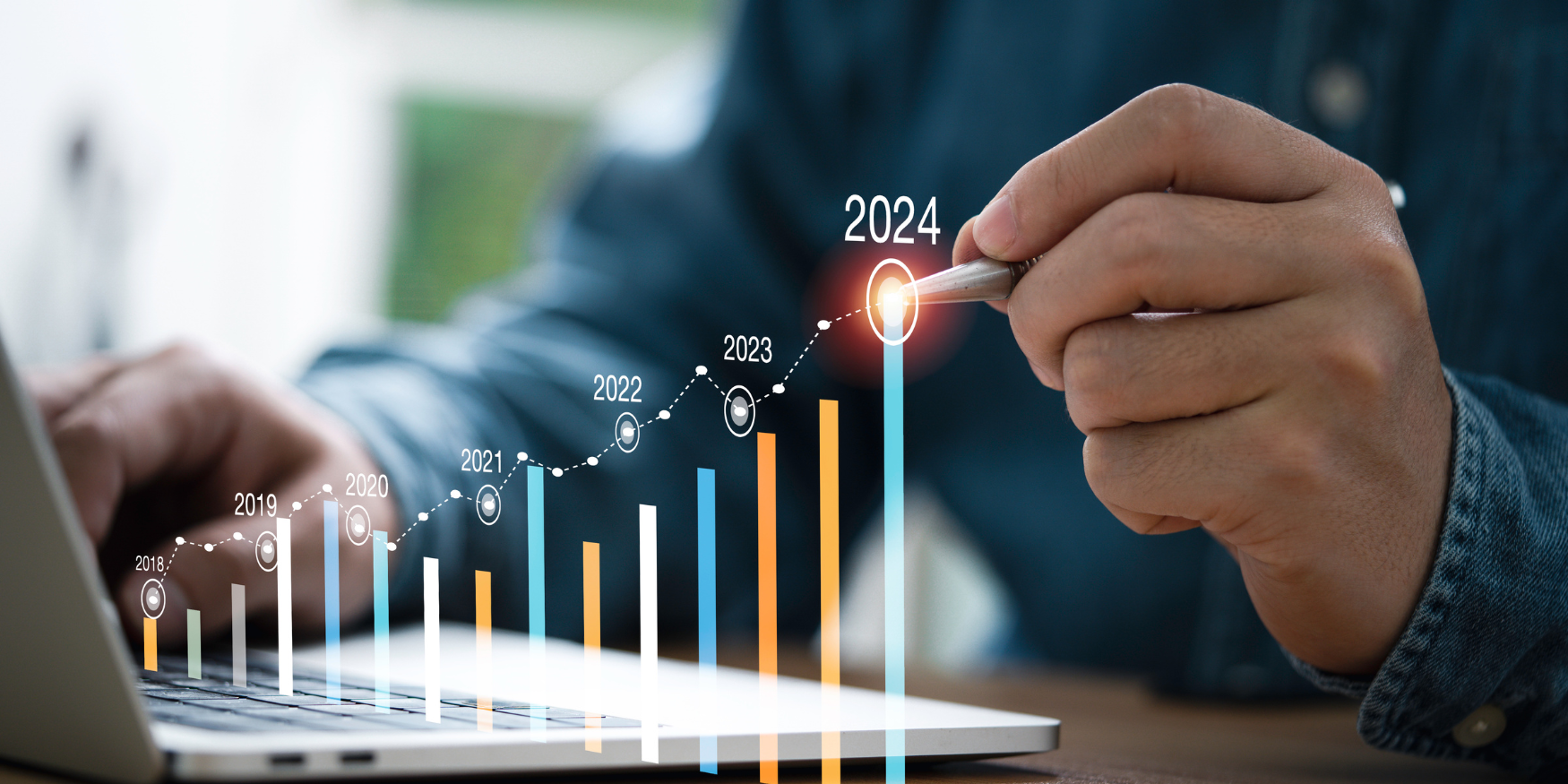 Hand pointing at a screen with a bar chart showing growth up and to the right