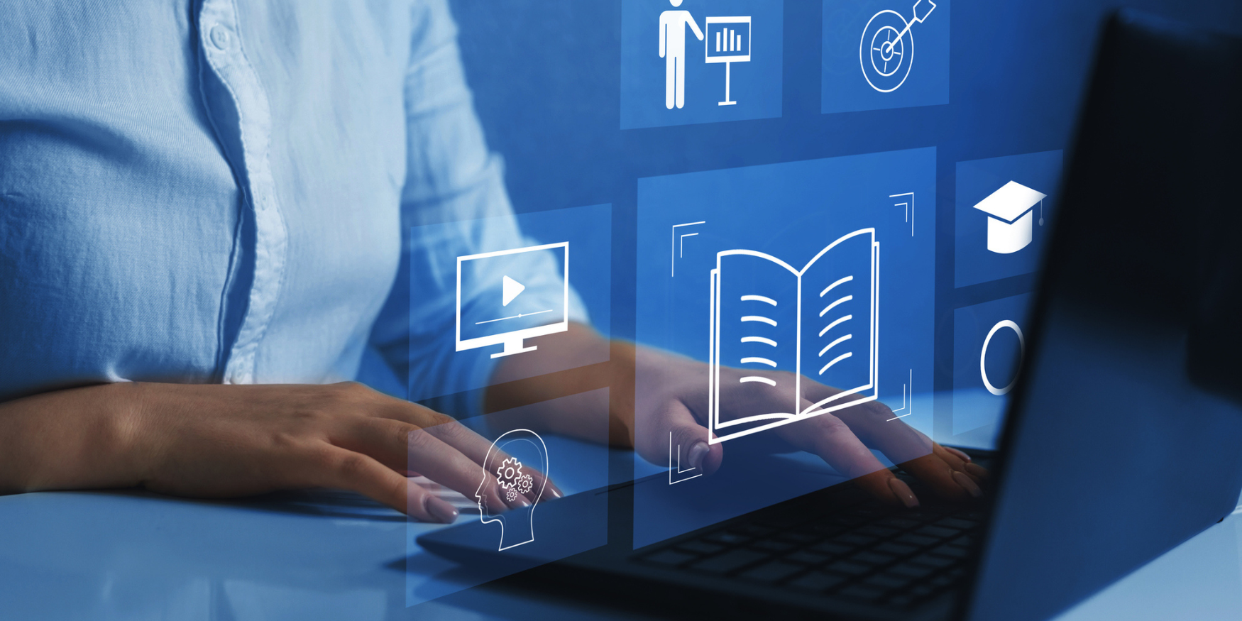 Hands at a keyboard with digital icons on the screen