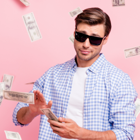 Man in sunglasses throwing dollar bills into the air