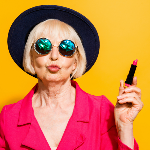 Puckering woman in sunglasses and a black wide-brimmed hat