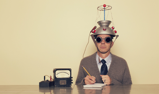 Old-school photo of scientist with a colander on his head doing a test