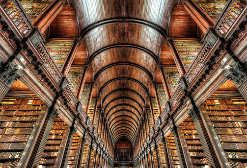 A vast library filled with sleek angles and rows and rows of books. 