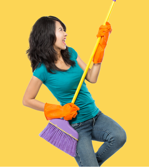 Woman holding a broom like a guitar