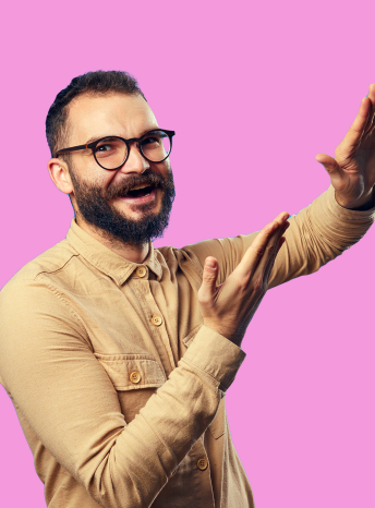 Smiling man in brown shirt with hands raised